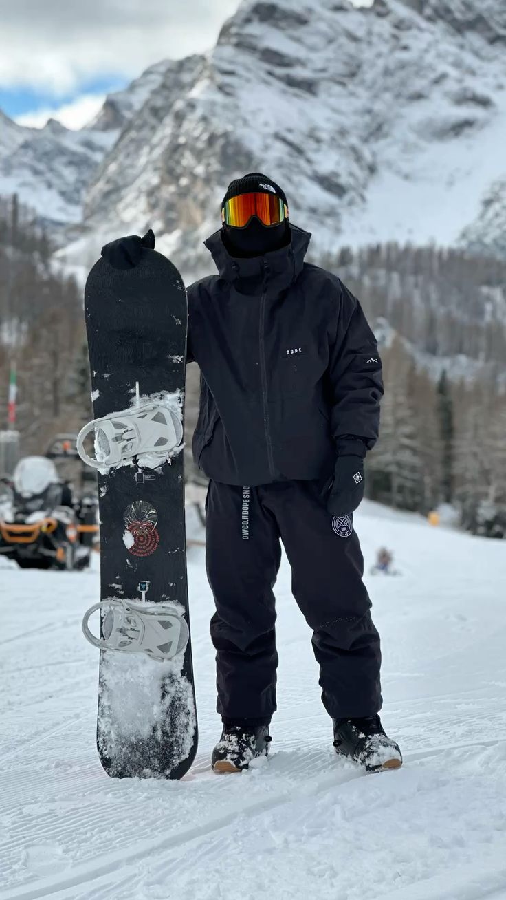 Snowboarder mid-jump with snow spray at golden hour