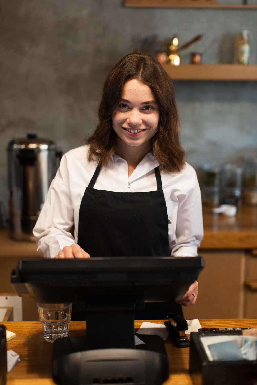Michelle, barista at Resto Bistro, smiling behind the counter